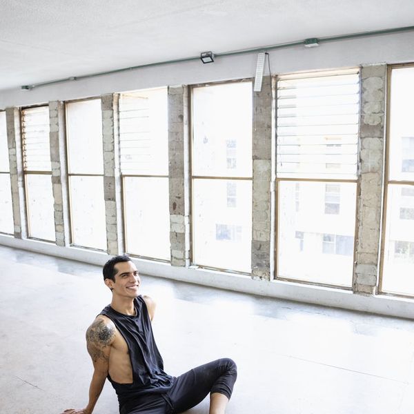 Person stretching in a bright, modern studio, feeling energetic.
